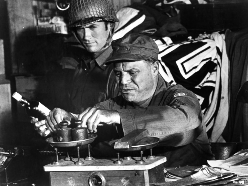 PHOTO: Clint Eastwood watches as Don Rickles weighs his captured ingots in a scene from the film Kellys Heroes, 1970.