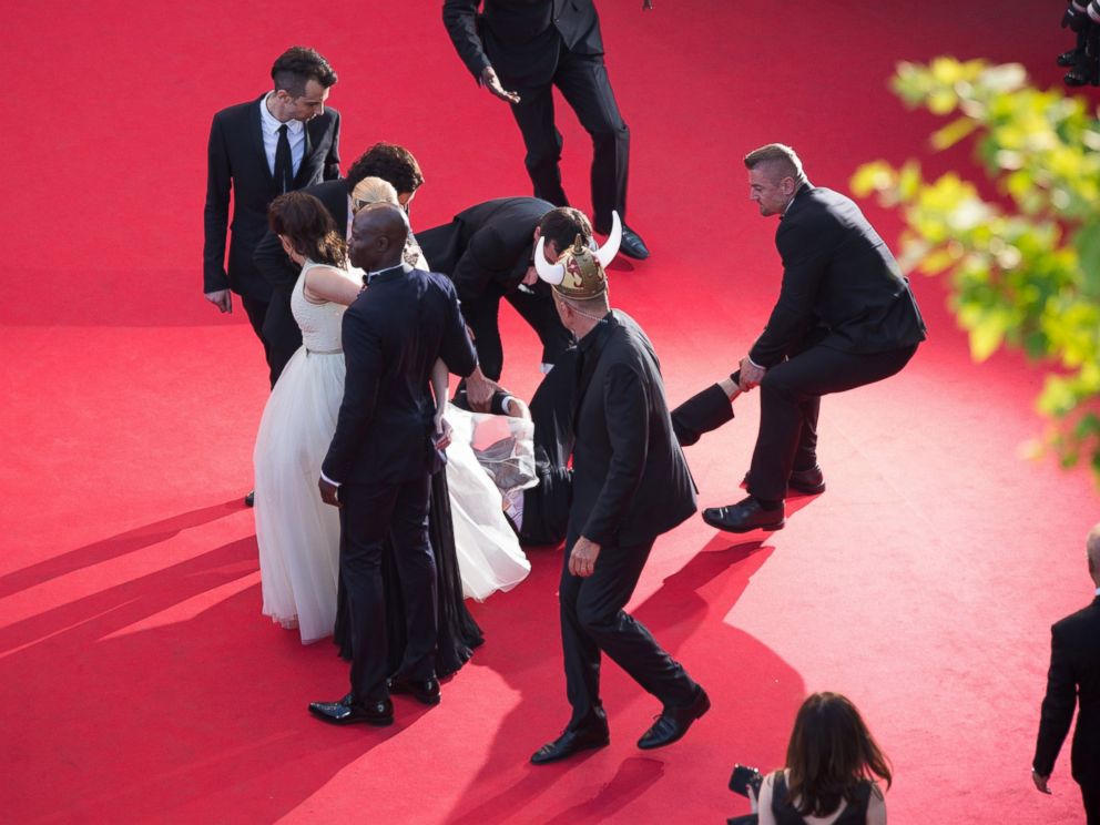 PHOTO: A man is held by security at the How To Train Your Dragon 2 premiere during the 67th Annual Cannes Film Festival on May 16, 2014 in Cannes, France.