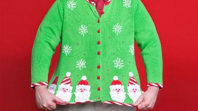 A man showing his Christmas sweater.