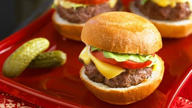 PHOTO: These mini sliders are topped with cheddar, pickles and ketchup.