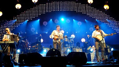 PHOTO: Ben Lovett, Marcus Mumford and Wynston Marshall of Mumford & Sons perform on stage at 02 Arena, Dec. 11, 2012 in London.