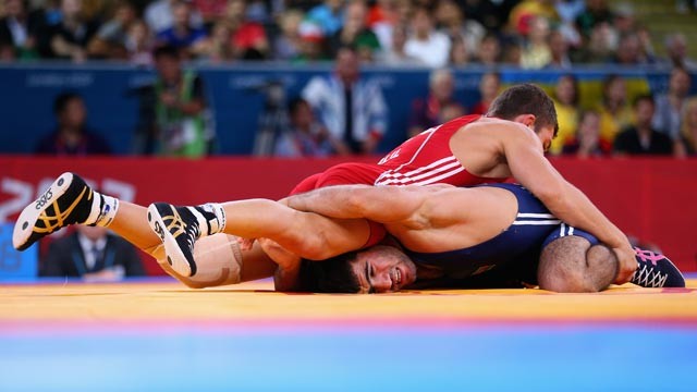 PHOTO: Jabrayil Hasanov of Azerbaijan in action against Leonid Anatolievich Bazan of Bulgaria in the Men's Freestyle Wrestling 66kg 1/8 final match of the London 2012 Olympic Games, Aug. 12, 2012, in London.