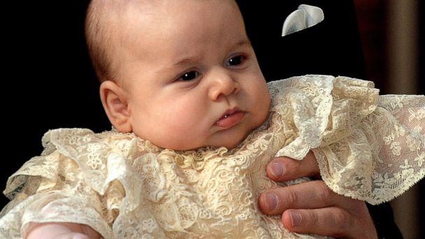 PHOTO: Britains Prince William, Duke of Cambridge holds his son, Prince George of Cambridge, as he arrives at Chapel Royal in St Jamess Palace in central London for the christening of the three month-old baby on October 23, 2013. 