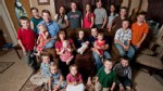 PHOTO: Michelle Duggar, bottom center, poses with her family for a portrait session.