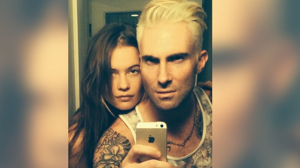 PHOTO: Adam Levine shows off his new hair color alongside fiancée Behati Prinsloo, May 3, 2014.