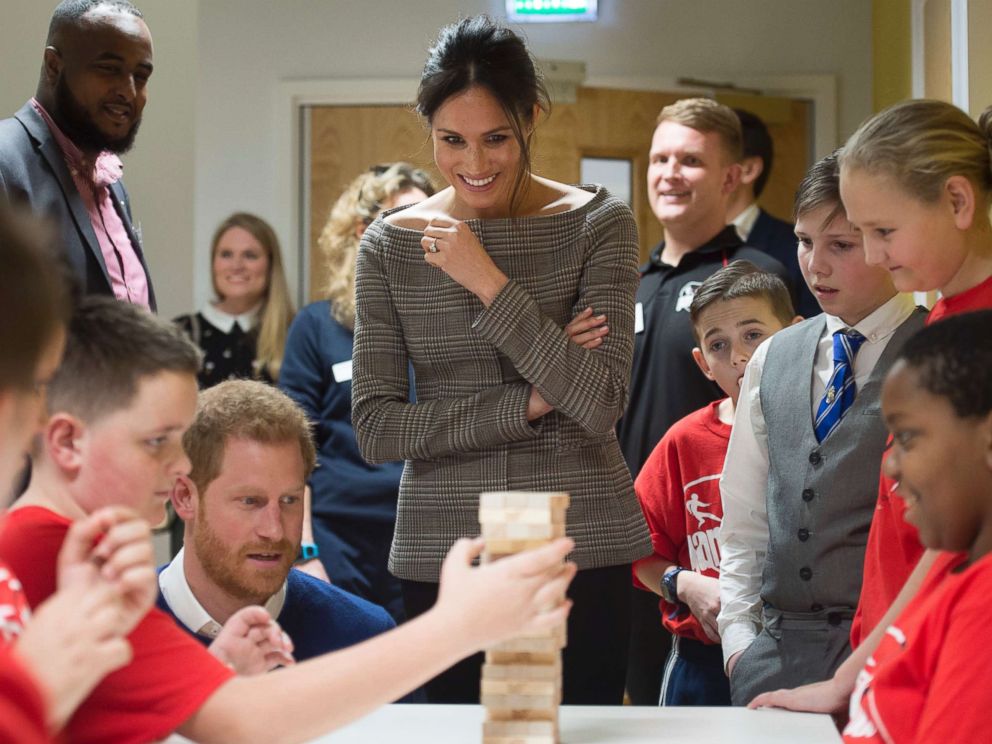 PHOTO: Britains Prince Harry and Meghan Markle reacts as they watch a game of Jenga, during a visit to Star Hub, a community and leisure center in Cardiff, Wales, Jan. 18, 2018. 