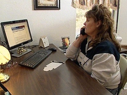 VIDEO: A woman on the phone at a desk.