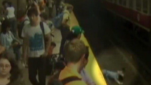 VIDEO: Frightening moment caught on tape shows straphangers rushing to aid of mother, son.