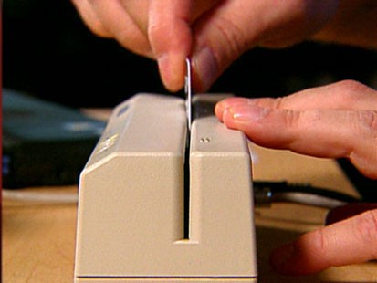 A picture of a credit card being used.