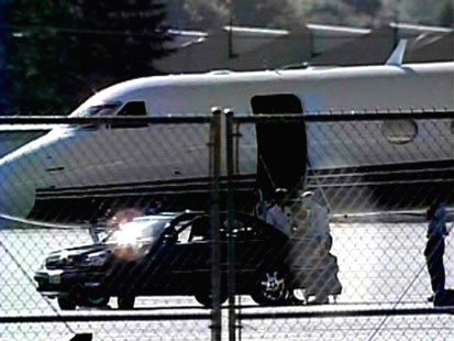 A picture of an automotive executive getting off of a private jet.