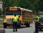 Man points rifle at school bus