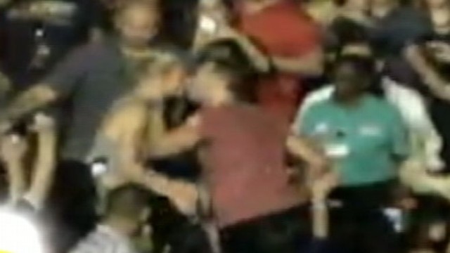 VIDEO: The Coldplay singer darted into the crowd mid- concert to give his wife a kiss.