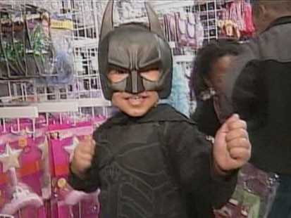 A picture of a little boy in a Batman costume.