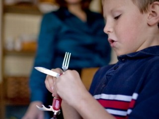 First Grader With Camping Utensils Suspended