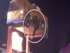 A picture of a woman and her child hanging from a carnival ride.