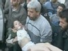 VIDEO: A man carrying an injured boy.