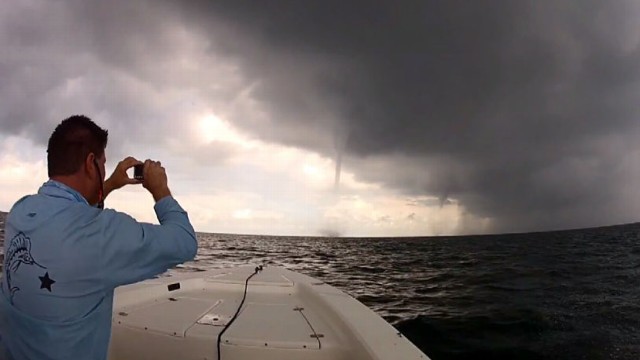 VIDEO: Kevin Johnson and his friend filmed themselves driving their boat through dangerous water spouts.