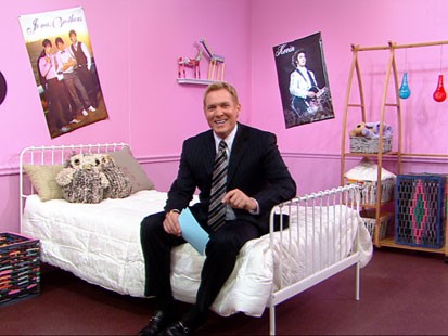 VIDEO: Sam Champion sitting in a green bedroom.
