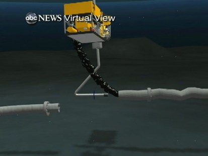 VIDEO: Tube inserted into broken well pipe is siphoning some of the escaping oil.