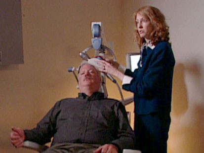 A picture of a man undergoing transcranial magnetic stimulation.