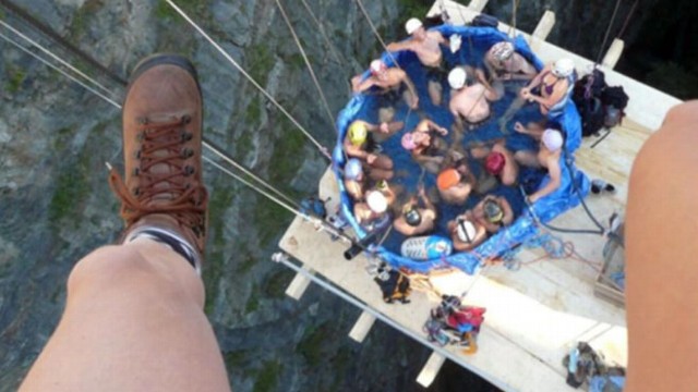 VIDEO: Photos show a group of people in hot tub suspended from a bridge.