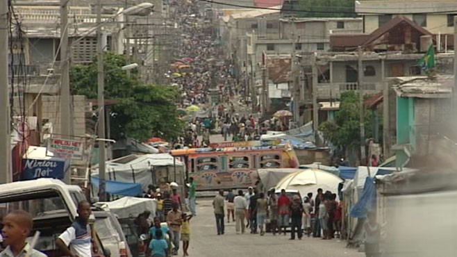 VIDEO: Citizens still live in tent cities, and orphans roam the streets.