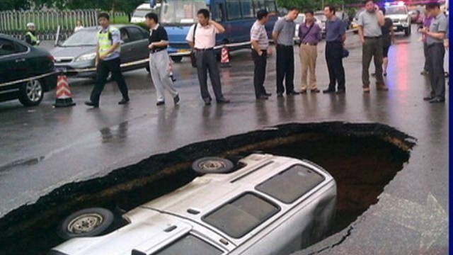 VIDEO: Watch what happened when a 6-foot deep sinkhole opened on a busy road.