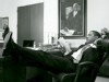A picture of Barack Obama reclining in his office.