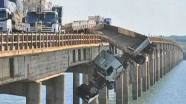 VIDEO: The driver hung off a bridge in Brazil for 30 minutes before being rescued.