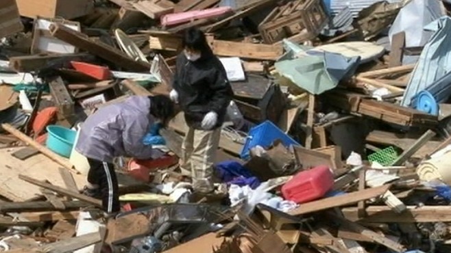 VIDEO: A community in Japan returns to their destroyed homes following tsunami.