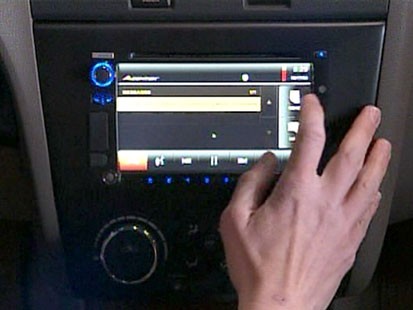 VIDEO: A hand touching a cars computer monitor.