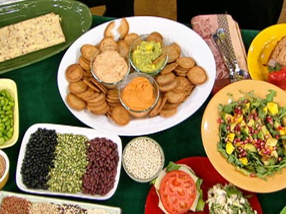 Diane Henderiks' creamy sundried tomato spread, roasted red pepper hummus, and mango guacamole are shown.