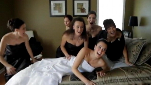 VIDEO: The weight of six women take down a mattress during photo shoot.