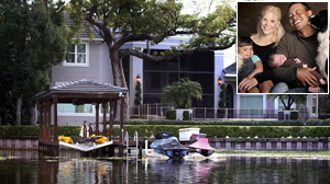 PHOTO The back of Tiger Woods home is seen on December 3, 2009 in Windermere, Florida./ Inset: In this photo provided by the Tiger Woods family, from left: Sam, Elin, Tiger, and Charlie Woods, are shown in this file photo.
