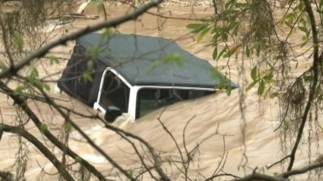 Rescuers brought five adults and seven children to safety after they were trapped by rising water.
