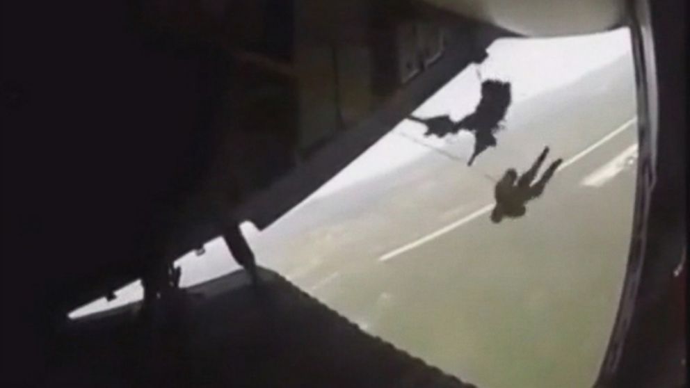 VIDEO: The soldier was left dangling from a plane after his parachute got caught during a military exercise in Mexico.