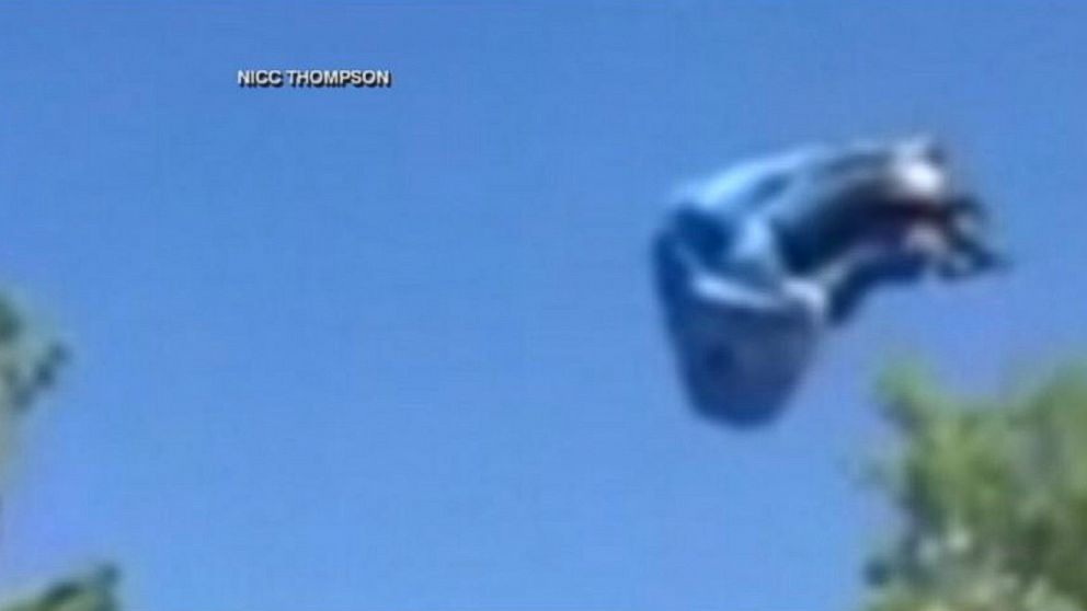 PHOTO: A bounce house went airborne, slamming into lamp posts and a car, July 4, 2014.