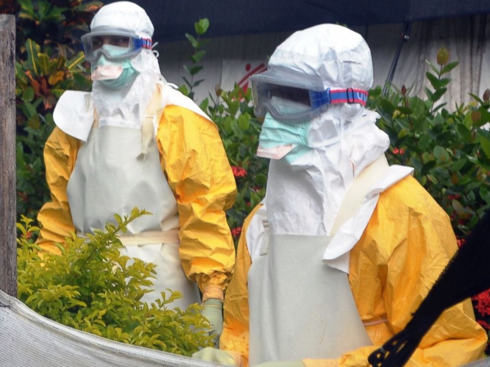 PHOTO: Members of Doctors Without Borders are pictured wearing protective gear outside an isolation ward of the Donka Hospital on July 23, 2014 in Conakry, Guinea.