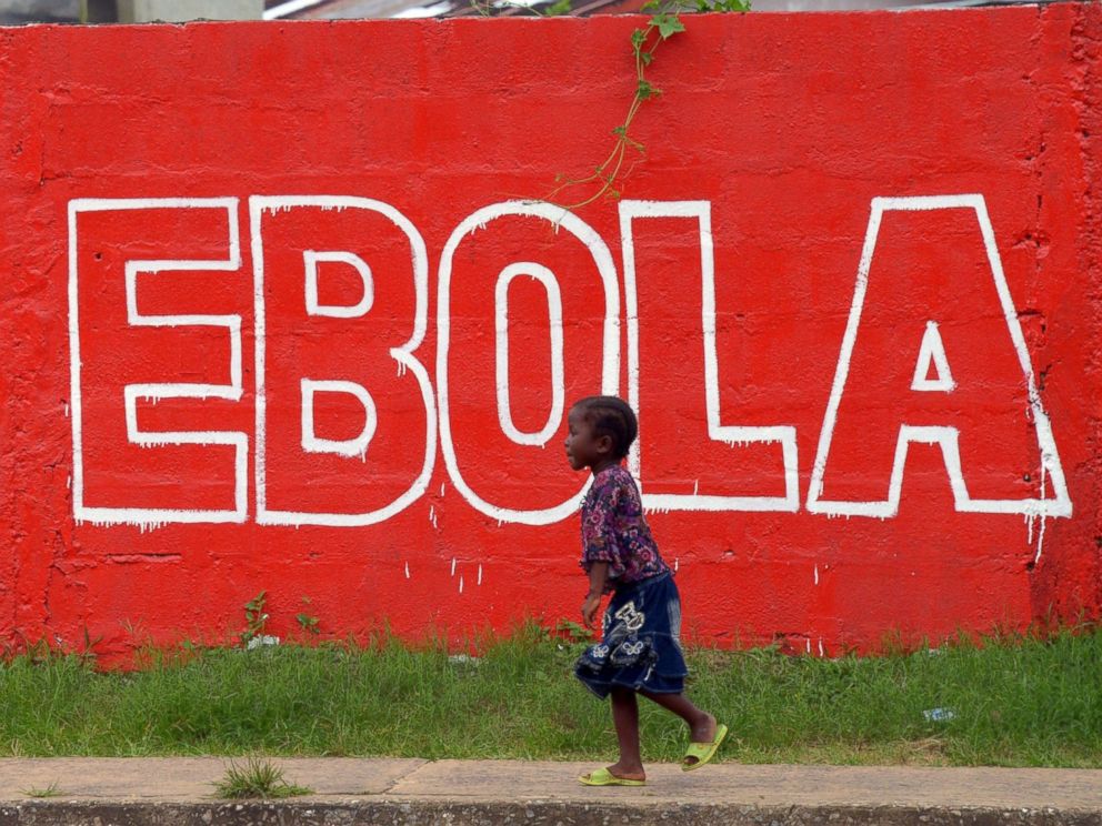 PHOTO: A girl walks past a painted wall reading Stop Ebola in Monrovia, Liberia on Aug. 31, 2014. 