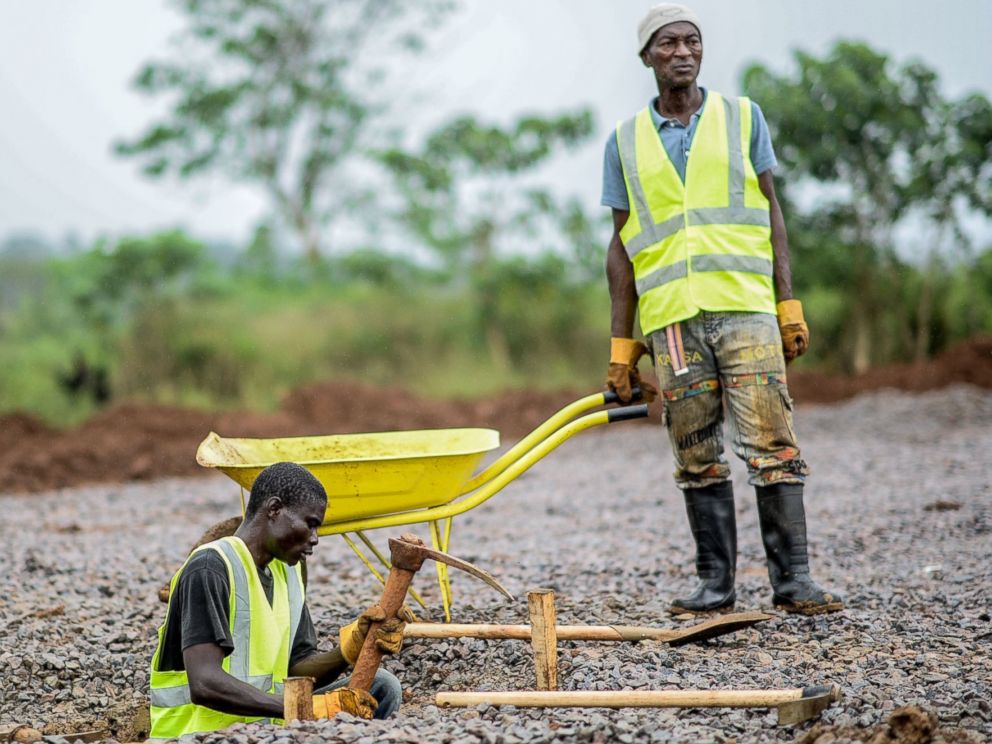 PHOTO: A worker from the International Committee of the Red Cross digs a hole with a pickaxe during the construction a brand new health center in Kenema, Sierra Leone on Aug. 25, 2014.