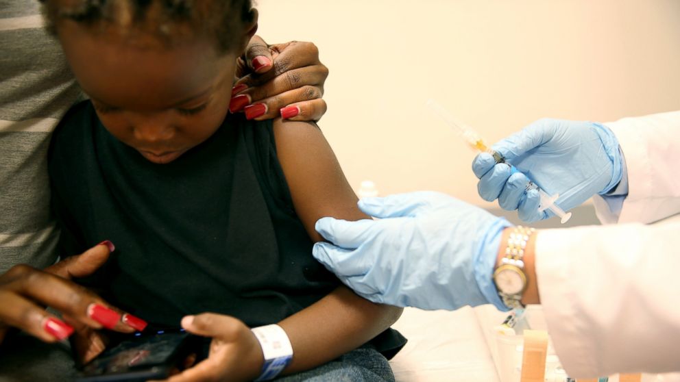 PHOTO: A mother holds her son as a pediatrician administers a measles vaccination during a visit to the Miami Childrens Hospital, May 16, 2014, in Miami.