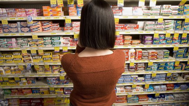 PHOTO: A woman browses for medicine at a pharmacy.