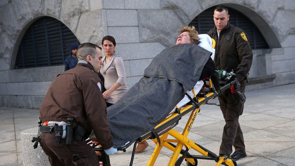 PHOTO: Linda Pelletier was taken away by EMTs after she collapsed inside the hallway of the courthouse hearing regarding the decision of her daugher, Feb. 24, 2014.