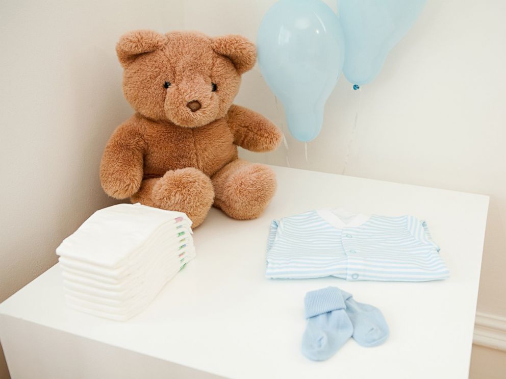 PHOTO: Baby clothes and teddy bear are set out for newborn baby in this undated stock photo.