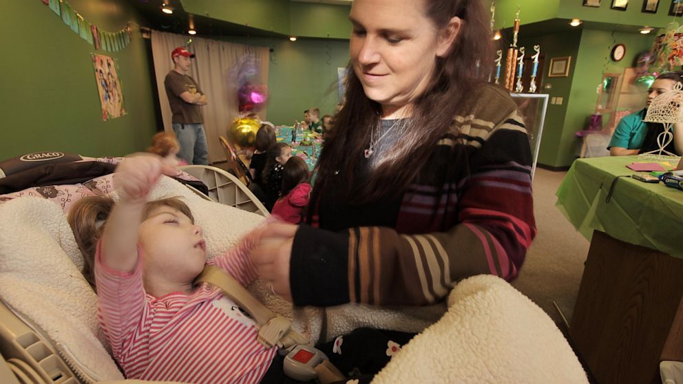 Gabby, shown here with her mother Mary Margret Williams, is 8 years old, but has barely aged, a condition that has baffled her doctors.