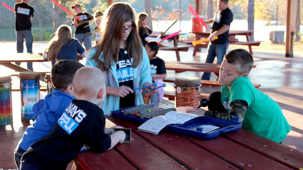 PHOTO: Campers enjoy activities like music and canoeing at Camp Painless But Hopeful