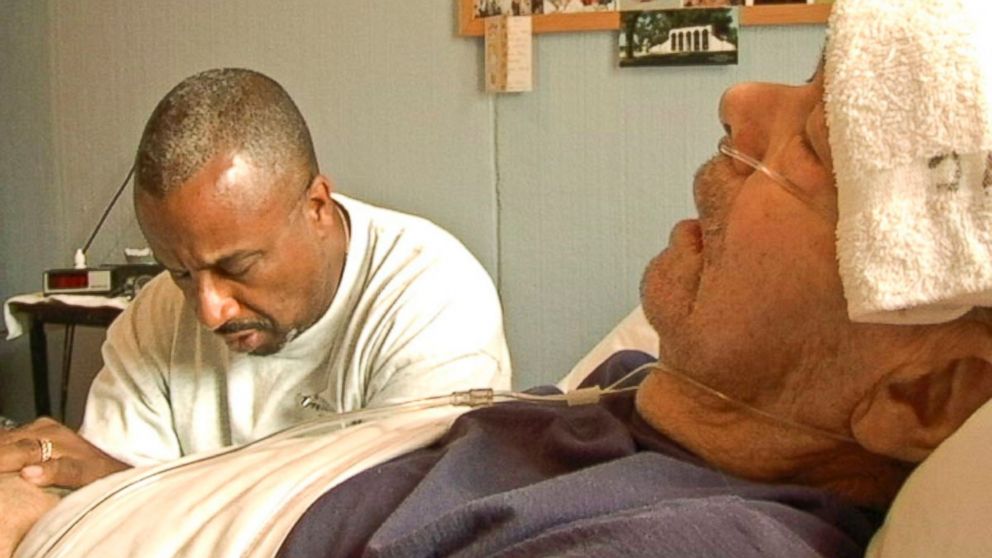PHOTO: A prison volunteer prays with dying Jack Hall in Iowa State Penitentiarys hospice program.