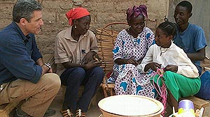 PHOTO: Dr. Besser and a family in Burkina Faso.