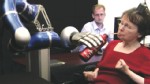 PHOTO: A paralyzed woman uses a mind-controlled robotic arm to drink from a bottle.