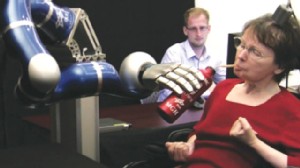 PHOTO: A paralyzed woman uses a mind-controlled robotic arm to drink from a bottle.